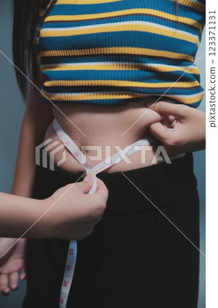 Women body fat belly. Obese woman hand holding excessive belly fat. diet lifestyle concept to reduce belly and shape up healthy stomach muscle. Women body fat belly. Obese woman hand holding excessive belly fat. diet lifestyle concept to reduce belly and shape up healthy stomach muscle. 123371131