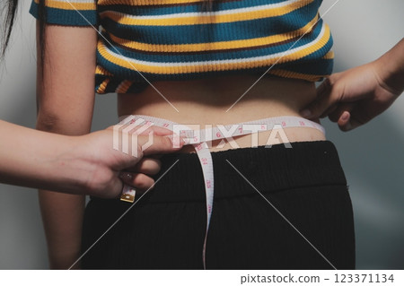 Women body fat belly. Obese woman hand holding excessive belly fat. diet lifestyle concept to reduce belly and shape up healthy stomach muscle. Women body fat belly. Obese woman hand holding excessive belly fat. diet lifestyle concept to reduce belly and shape up healthy stomach muscle. 123371134