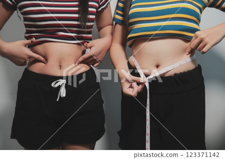Women body fat belly. Obese woman hand holding excessive belly fat. diet lifestyle concept to reduce belly and shape up healthy stomach muscle. 123371142