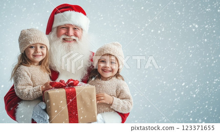 Santa Claus with two young girls, sharing gifts in a festive snowy setting. Heartwarming holiday scene. 123371655