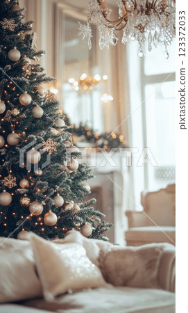 Beautiful Christmas tree with sparkling ornaments and golden lights in a living room. Festive decor for a Merry Christmas and New Year. 123372033
