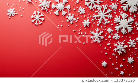 Red and white Christmas theme with scattered snowflakes over a vibrant backdrop, ideal for festive promotions. 123372150