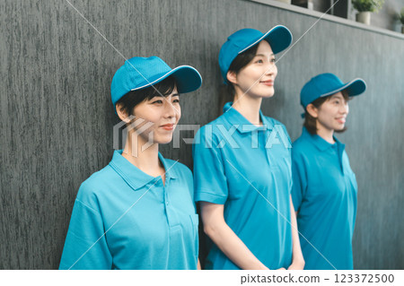 Female staff wearing blue polo shirt and hat Female staff wearing blue polo shirt and hat 123372500