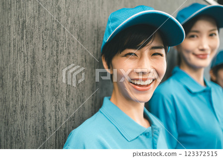Female staff wearing blue polo shirt and hat 123372515