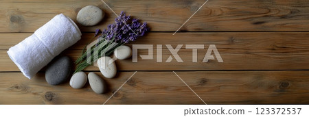 Immerse in serene spa setting with lavender, stones on rustic wood. Relax, unwind, rejuvenate with aromatherapy. Top view, copy space for holistic wellness 123372537