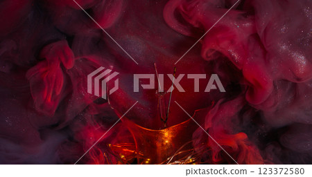 Shimmering cloud. Magical splash. Puff multicolor sparkling water emulsion streaming broken glass bulb. Glossy red paint surface abstract background. Shimmering cloud. Magical splash. Puff multicolor sparkling water emulsion streaming broken glass bulb. Glossy red paint surface abstract background. 123372580