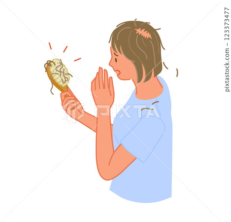 一位頭髮稀疏的年輕女子驚訝地看到她的梳子上有頭髮（頭髮稀疏的部分） 123373477