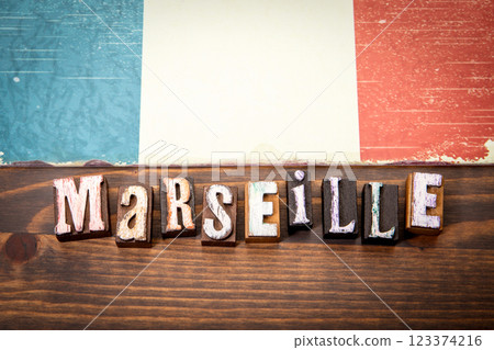 MARSEILLE. Flag and alphabet letters on wooden texture background MARSEILLE. Flag and alphabet letters on wooden texture background 123374216