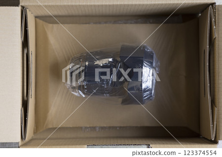 A camera lens packed in cardboard for repair 123374554
