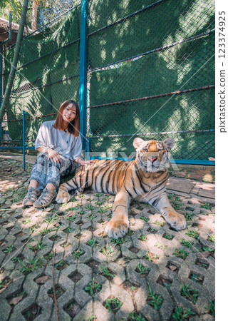 A woman sightseeing at Tiger Kingdom, a tourist spot in Thailand 123374925