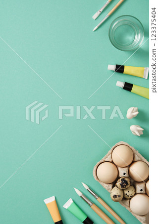 Preparation for Easter celebration. Painting Easter eggs with acrylic pigment dyes in tubes. Clean brown eggshells. 123375404