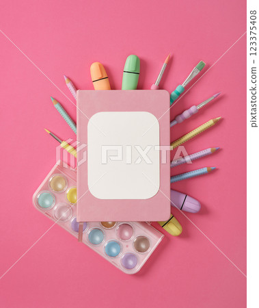 Composition of various art and drawing supplies in pastel colors on pink background. Space for your text. 123375408