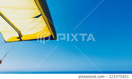 Bright Yellow Hang Glider Soaring over Clear Blue Ocean Horizon ai generative 123375851