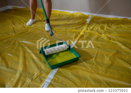 A Person Painting a Room with Great Caution and Care, Ensuring Every Detail is Perfect A Person Painting a Room with Great Caution and Care, Ensuring Every Detail is Perfect 123375931