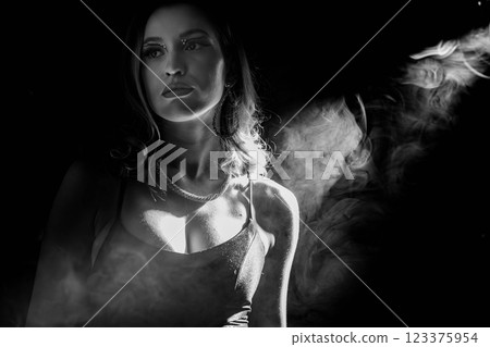 This is a Dramatic Portrait in Black and White featuring a Smoky Background that captivates 123375954