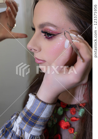 Makeup application with glamorous detail work showcases exquisite artistry and precision 123375956
