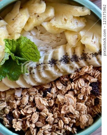 Smoothie bowl with bananas, berries, granola and other ingredients 123375962