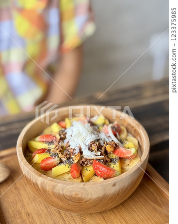 Smoothie bowl with bananas, berries, granola and other ingredients 123375985