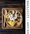 Smoothie bowl with bananas, berries, granola and other ingredients 123375998
