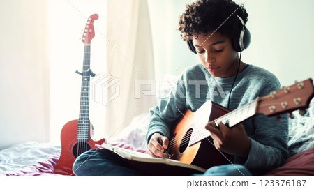 Teen Practicing Music with Acoustic Guitar and Headphones in Cozy Bedroom Setting ai generative ai generative Teen Practicing Music with Acoustic Guitar and Headphones in Cozy Bedroom Setting ai generative ai generative 123376187