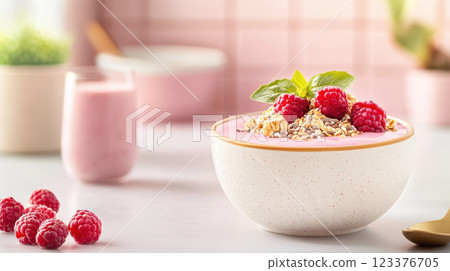 Delicious smoothie bowl topped with raspberries and granola 123376705