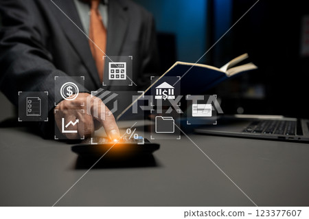 Business man take notes and use the calculator with calculations about the expenses at the office. 123377607