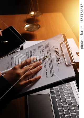 Attractive young lawyer in office Business woman and lawyers discussing contract papers with brass scale on wooden desk in office. Law, legal services, advice, Justice and real estate concept. 123378247