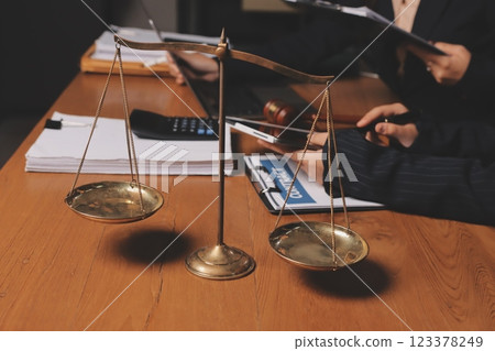 Attractive young lawyer in office Business woman and lawyers discussing contract papers with brass scale on wooden desk in office. Law, legal services, advice, Justice and real estate concept. Attractive young lawyer in office Business woman and lawyers discussing contract papers with brass scale on wooden desk in office. Law, legal services, advice, Justice and real estate concept. 123378249
