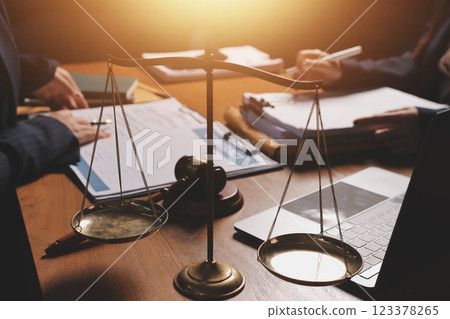 Attractive young lawyer in office Business woman and lawyers discussing contract papers with brass scale on wooden desk in office. Law, legal services, advice, Justice and real estate concept. Attractive young lawyer in office Business woman and lawyers discussing contract papers with brass scale on wooden desk in office. Law, legal services, advice, Justice and real estate concept. 123378265