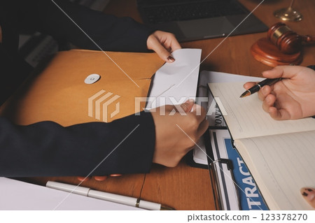 Attractive young lawyer in office Business woman and lawyers discussing contract papers with brass scale on wooden desk in office. Law, legal services, advice, Justice and real estate concept. Attractive young lawyer in office Business woman and lawyers discussing contract papers with brass scale on wooden desk in office. Law, legal services, advice, Justice and real estate concept. 123378270