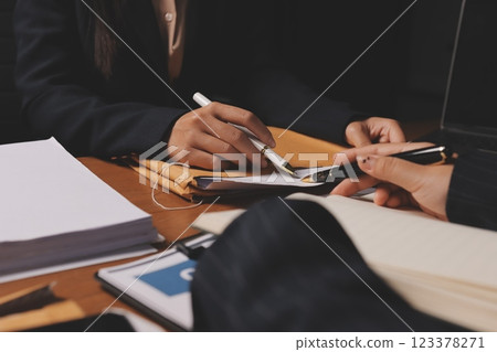 Attractive young lawyer in office Business woman and lawyers discussing contract papers with brass scale on wooden desk in office. Law, legal services, advice, Justice and real estate concept. 123378271