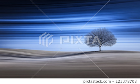 Solitary tree stands gracefully in a serene twilight landscape 123378708