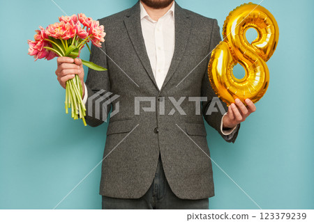 Man with bouquet of tulips and balloon number 8 Man with bouquet of tulips and balloon number 8 123379239