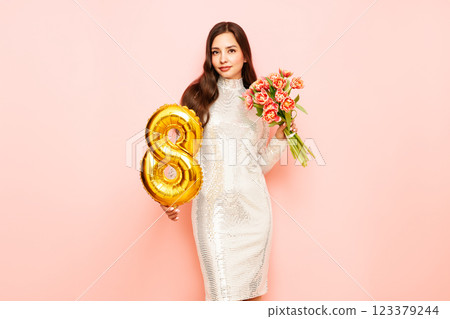Woman hold bouquet of flowers and balloon number 8 123379244
