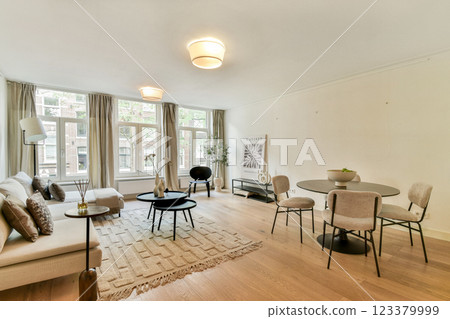 A stylish modern living room featuring contemporary furniture, natural light, and a cozy ambiance. Perfect for relaxing or socializing. A stylish modern living room featuring contemporary furniture, natural light, and a cozy ambiance. Perfect for relaxing or socializing. 123379999