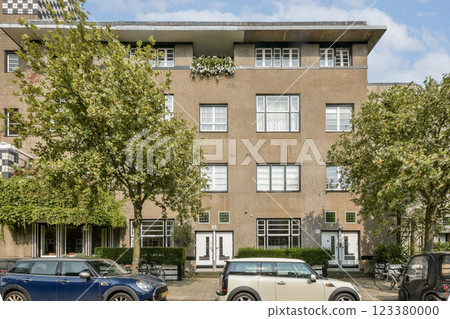 A contemporary apartment complex featuring sleek architecture and lush greenery, showcasing urban living and design efficiency. A contemporary apartment complex featuring sleek architecture and lush greenery, showcasing urban living and design efficiency. 123380000