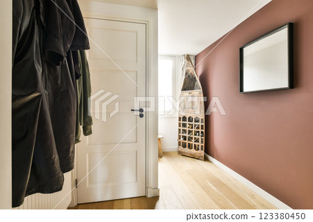 A stylish modern hallway featuring a minimalist design with warm tones, natural light, and artistic elements. The perfect blend of function and aesthetics. A stylish modern hallway featuring a minimalist design with warm tones, natural light, and artistic elements. The perfect blend of function and aesthetics. 123380450