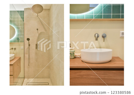 Elegant modern bathroom featuring a glass-enclosed shower and stylish sink setup, complemented by minimalistic decor and soothing colors. 123380586