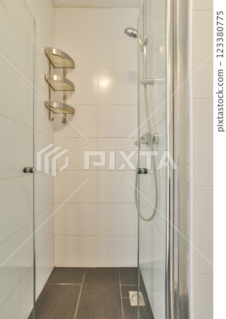 Sleek and contemporary shower design featuring glass panels and minimalist fixtures, ideal for modern bathrooms. A perfect blend of style and functionality. Sleek and contemporary shower design featuring glass panels and minimalist fixtures, ideal for modern bathrooms. A perfect blend of style and functionality. 123380775