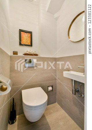 A sleek and modern bathroom showcasing a minimalist toilet, stylish mirror, and contemporary fixtures, creating a clean aesthetic for small spaces. 123381122