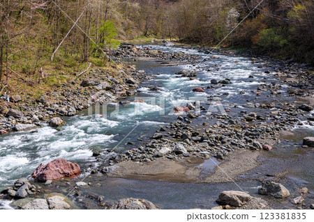 Springtime Mukawa River flowing through the mountains in Shimukappu Village, Hokkaido [May] 123381835