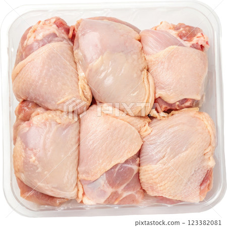 Uncooked Chicken Thighs in Plastic Tray on Plain White Background for Food Photography Uncooked Chicken Thighs in Plastic Tray on Plain White Background for Food Photography 123382081