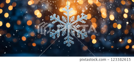 Hanging snowflake decoration is gently swaying on blurred christmas lights background 123382615
