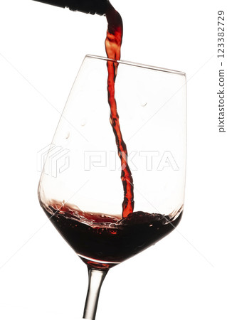 Red wine being poured in glass 123382729