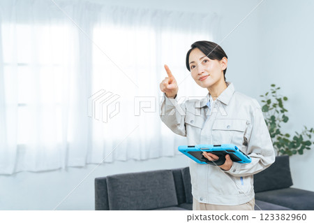 A female worker checking the room with a tablet 123382960