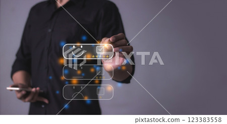 Young man with smartphone mobile hand holding a pen touching to five star to review and give 5 stars Young man with smartphone mobile hand holding a pen touching to five star to review and give 5 stars 123383558
