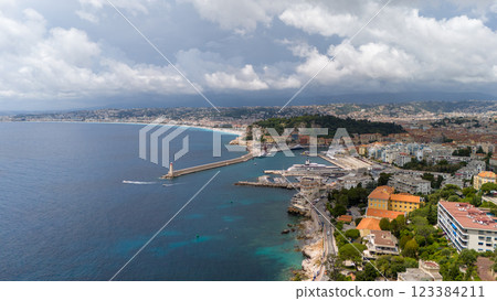 Aerial View Of Nice, France, Showcasing The Scenic Harbor, A Lighthouse, And The Expansive Mediterranean Coastline With A Vibrant Cityscape 123384211