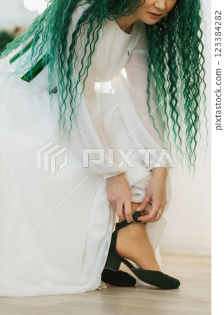 portrait of a bride with green curly hair in the beauty room portrait of a bride with green curly hair in the beauty room 123384282