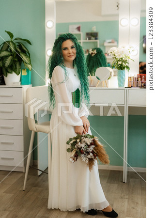 portrait of a bride with green curly hair in the beauty room 123384309