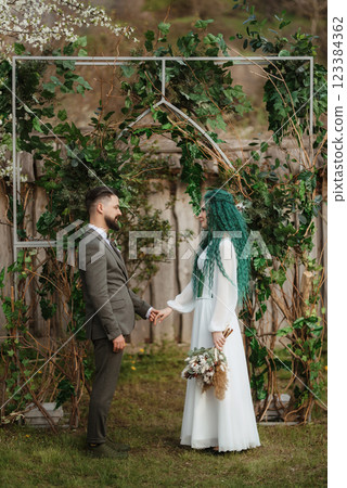 wedding ceremony of the newlyweds in a country cottage 123384362